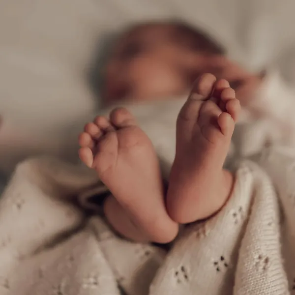 Newbornshooting: winzige Babyfüße auf einer gestrickten Decke